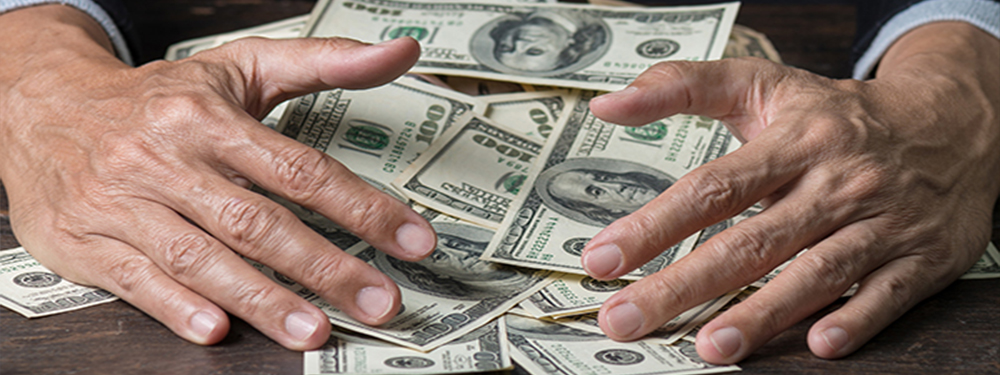 Picture of a pair of hands scooping up a pile of money